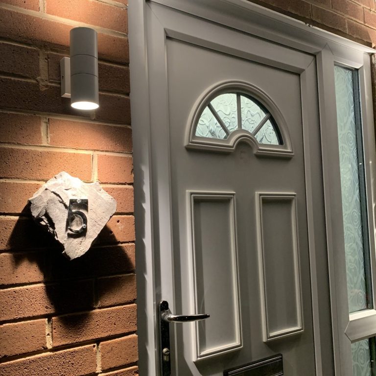 outside light beside a domestic front door which illuminates the house number
