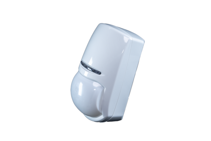 Wireless intruder alarm detector KX1 shown in isolation from background, and at an angle so as to see the shape 